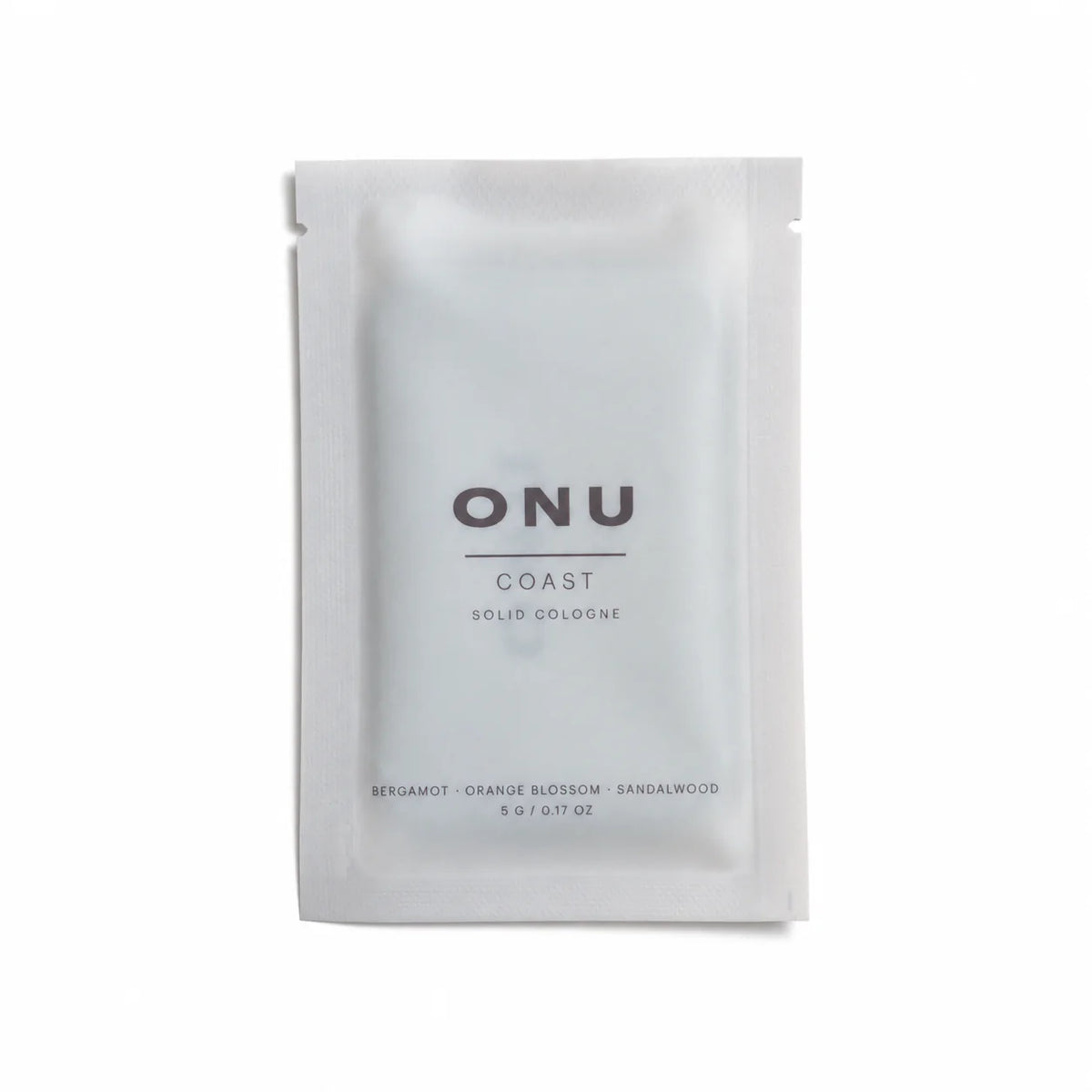 Silver ONU COAST solid balm cologne sachet on a clean white background.
