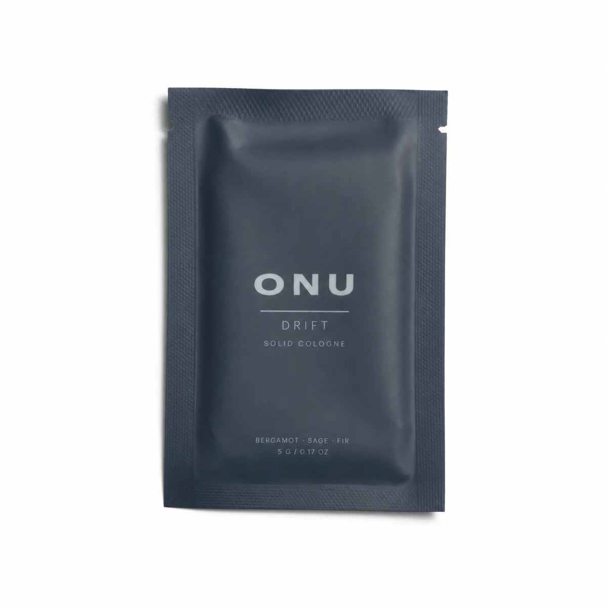 Deep navy ONU DRIFT solid balm cologne sachet on a clean white background.