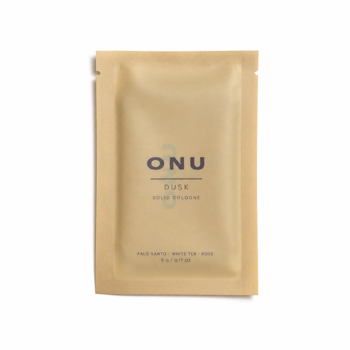 Gold ONU DUSK solid balm cologne sachet on a clean white background.