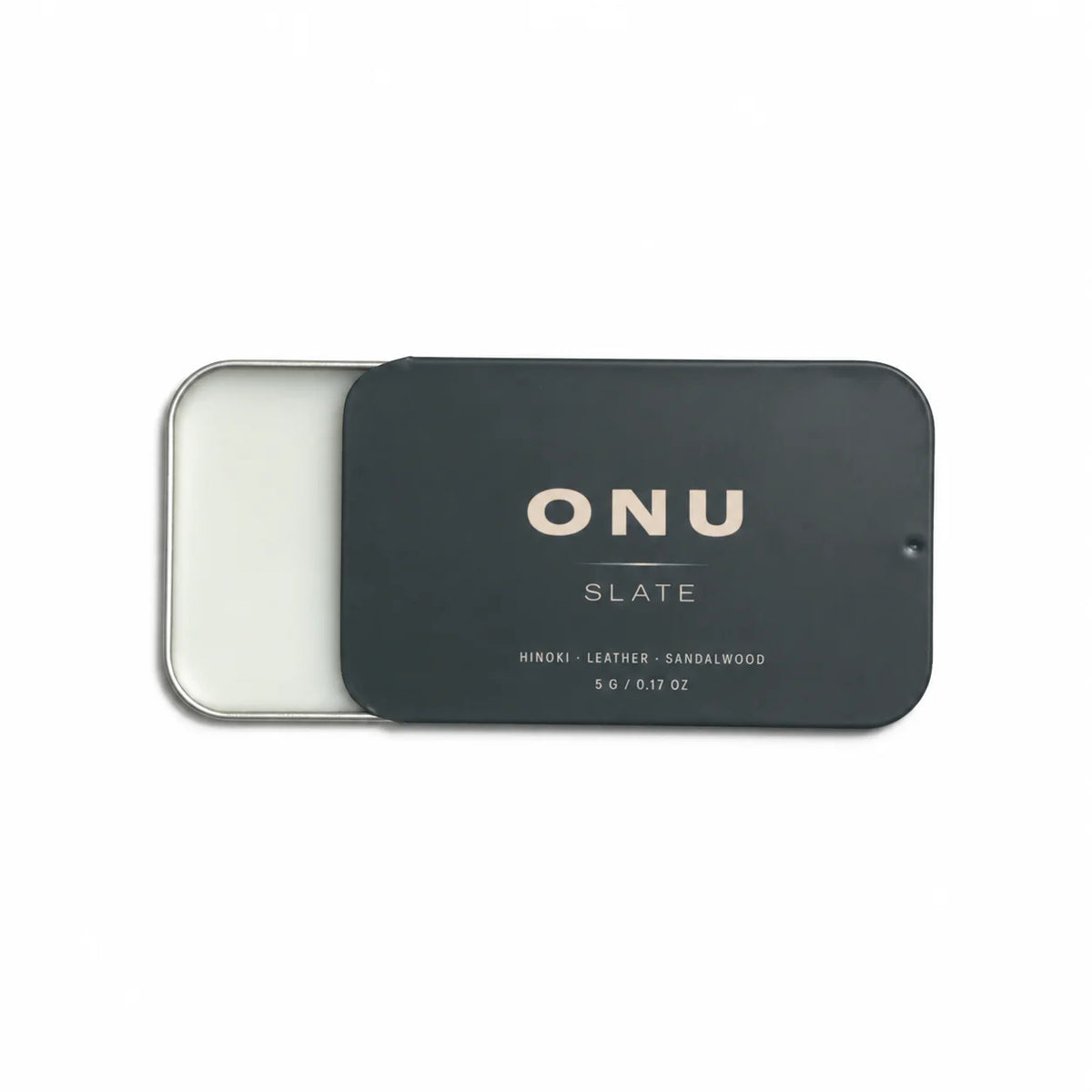 Open deep green ONU SLATE solid balm cologne card showing the white balm on a clean white background.